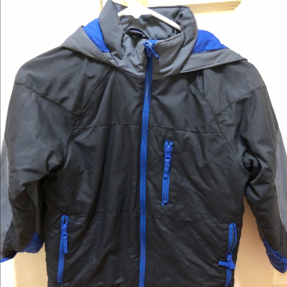 Children place small boy coat